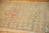 Worn texture and muted sage and red diamond patterns on a vintage distressed Oushak rug.