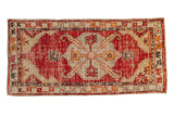 Vintage distressed Oushak runner with a cherry red field, a large diamond-shaped medallion, and gold accents.