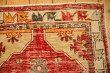 Corner detail of a vintage Oushak rug runner with its intact selvage and geometric borders.
