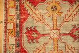 Intact side cord selvage and worn pile of a distressed Oushak rug with red serrated motifs.