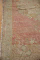 The even wear to the knot heads and restored side cord of a vintage Oushak runner rug.