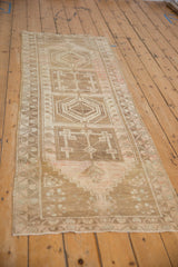 Distressed Anatolian runner's geometric medallion, serrated leaf border, and soft blush abrashes.