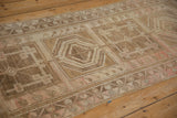 Close-up of distressed Anatolian runner showcasing square medallions, germinating blossoms, and soft blush abrashes.