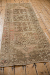 Close-up of distressed Anatolian runner with pineapple finial medallions and heavy abrashes.