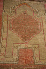 Distressed Kars rug detail showing coral hexagonal medallion, interconnected seeds, and heavy abrashes.