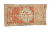 Vintage distressed Oushak runner with a geometric medallion in soft cherry red, sand, and silver-teal.