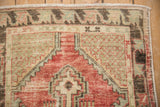 Vintage distressed Oushak runner detail: corner spandrel with germinating seeds in lattice, faded red and celadon.