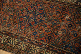 Antique Hamadan rug: meandering vine border meets Herati field, madder red, sapphire blue tones.