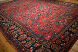 Vintage Hamadan carpet: ruby red field, artful floral motifs, deep sapphire border.