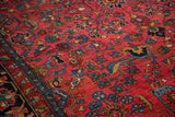 Vintage Hamadan carpet detail: nuanced floral sprays on ruby red field with sapphire blue and gold.