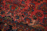 Intricate floral sprays on ruby red vintage Hamadan rug with deep blue border and patina.