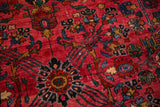 Vibrant ruby red field with gem-like floral sprays on a vintage Hamadan rug.