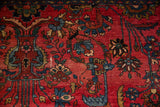 Nuanced floral sprays, inwardly directed vase, and gem-like shades on a ruby red field.