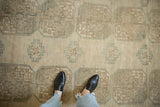 Distressed Ersari carpet with geometric floral guls, abrashed beige, and dusty teal tones.