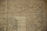 Distressed vintage Ersari rug detail: geometric guls, sandy beige, dusty teal, and even wear.