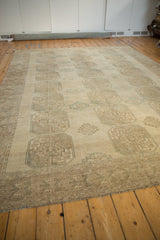 Distressed texture of repeating geometric Ersari guls on an abrashed beige ground.