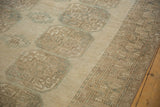 Distressed Ersari carpet detail showing geometric guls, abrashed ground, and textured patterned border.