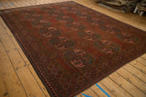 Distressed Ersari carpet detail showing geometric guls, abrash, chestnut red, and dusty rose.