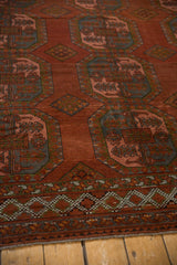 Distressed vintage Ersari carpet lower border, with checkered, chestnut, green, and blush motifs.
