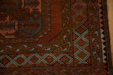 Distressed Ersari rug corner with geometric guls, chestnut red, charcoal, green borders, and selvage.