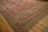 Corner of a distressed Ersari carpet with geometric gul medallions and time-softened red hues.