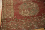 Low pile and geometric border next to a hexagonal gul on a distressed Ersari carpet.