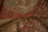 A fold in the vintage Ersari carpet shows the distressed, hand-knotted texture and low pile.