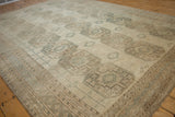Distressed vintage Ersari carpet with muted gul medallions and geometric border.