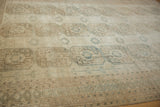 Distressed vintage Afghani Ersari rug detail: worn gul medallions, geometric border, muted tones.