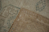 Vintage distressed Ersari rug, worn beige pile, dusty teal pattern, and woven foundation.