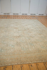Visible distressed texture and muted gul medallions on a vintage Oushak carpet.