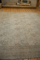 Distressed Oushak rug border detail, geometric pattern, faded field in ivory and pale teal tones.