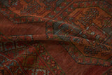 Ersari carpet's worn pile reveals gul medallions, delicate vine patterns in burgundy, soft teal.
