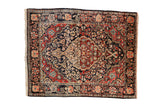 Vintage Josan Sarouk rug with a scalloped medallion and floral blossoms in navy blue, brick red, and ivory.