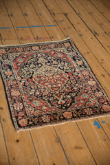 Angled view of the vintage Josan Sarouk rug's intricate floral pattern in navy, red, and ivory tones.