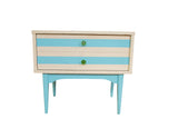 Updated Mid Century nightstand with ivory and aqua stripes, green glass knobs, and tapered aqua legs.