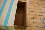 Open drawer of the vintage nightstand revealing its original, unpainted wood interior.