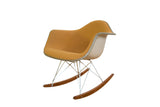 Vintage Eames Herman Miller rocking chair with ochre fabric, a light beige shell, and wood runners.