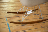 Steel wire frame and newer wooden runners of the Eames Herman Miller rocking chair base.