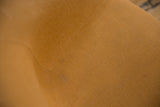Detail of the vintage Eames chair's original golden-brown Girard fabric and texture.