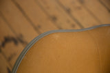 Close-up of the Eames chair's original ochre Girard fabric weave and grey edge piping.