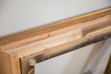 Vintage Golden Wood Picture Frame, close-up showing natural wood joinery and visible staples.
