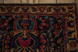 Corner detail of a Mohajeran Sarouk showing the ivory-shaded border and deep blue floral field.