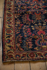 Intricate ivory border and floral motifs on the deep indigo blue field of an antique Mohajeran Sarouk.