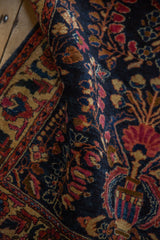 Intricate floral sprays and pinwheel blossoms in gem-tones on an antique Mohajeran Sarouk rug.