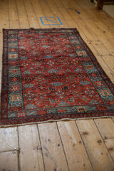 High-angle view of a vintage Hamadan rug showing its full length and traditional Herati pattern.