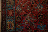Close-up of the crab-style border and ruby red Herati field on a vintage Hamadan rug.