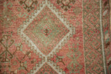 A close view of a medallion gul with a hook-and-latch outline showing the rug's even, low-pile texture.