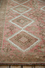 A close look at the low-pile texture and geometric gul motifs in dusty blush and silver.