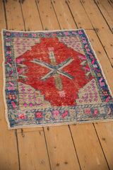 Distressed vintage Oushak rug texture, showing cherry red, sapphire blue, and fuchsia.
